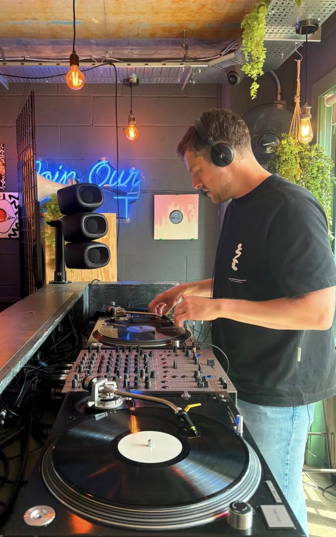 Cafe Haus DJ playing vinyl in a small venue
