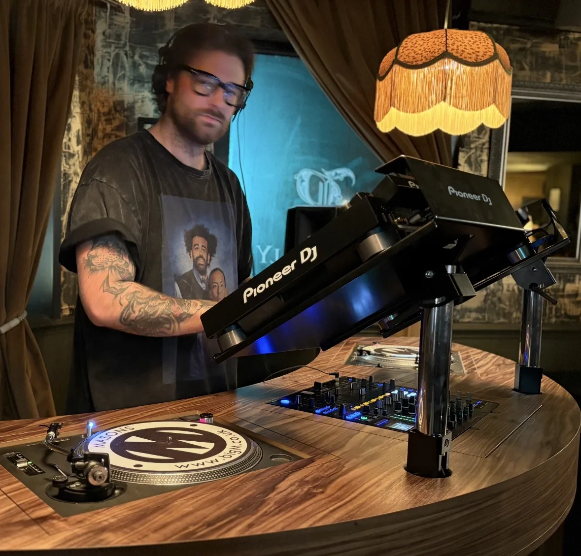 Cafe Haus DJ behind a vinyl setup